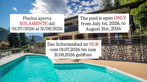 a sign for a swimming pool in front of a house at Residence Panorama in Molina di Ledro