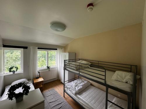 a bedroom with a bunk bed and two windows at Sörbyvägen 4 in Floby