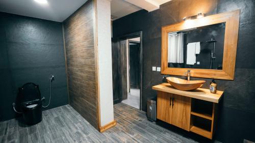a bathroom with a sink and a mirror at Skojet Boutique Hotel in Ruhengeri