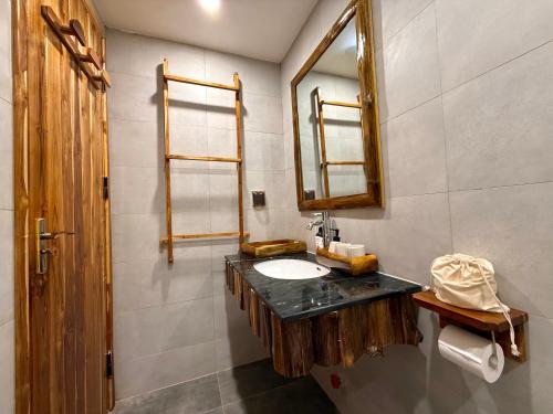 a bathroom with a sink and a mirror at Suối Mộc Ecostay - Mộc Châu in Mộc Châu