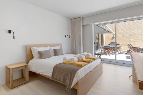 a bedroom with a bed with towels on it at Viana Vista Villa in Viana do Castelo
