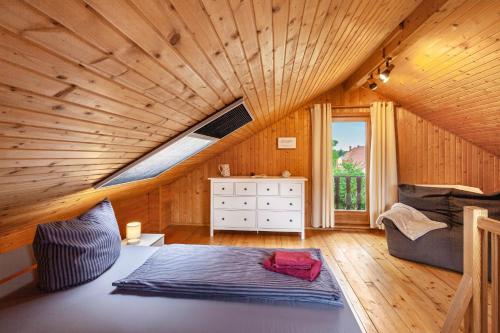 a bedroom with a large bed in a wooden room at Ferienhaus Sonne in Hohnstein