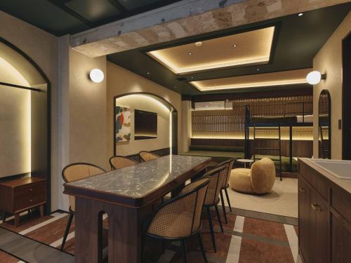 a room with a bar with chairs and a kitchen at illi Harb Shibuya-Ebisu in Tokyo