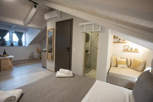 a bedroom with a large bed and a bathroom at Cosmopolitan Suites in Parga