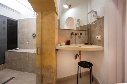a bathroom with a sink and a shower at Kore in Noto