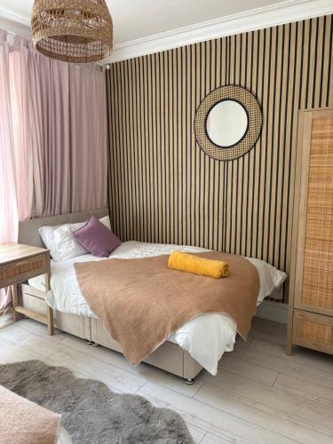 a bedroom with a bed and a mirror on the wall at Sea view Villa Holiday and Corporate Let Accommodation in Prestwick