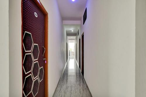 a hallway with a door with a design on it at Hotel O My Choice in Indore