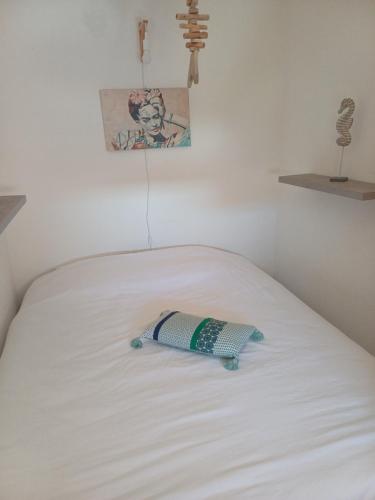 a toy on top of a white bed at Le goéland in Port Leucate