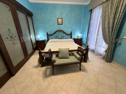 a bedroom with a bed in a blue room at Villa Aurea in Avola