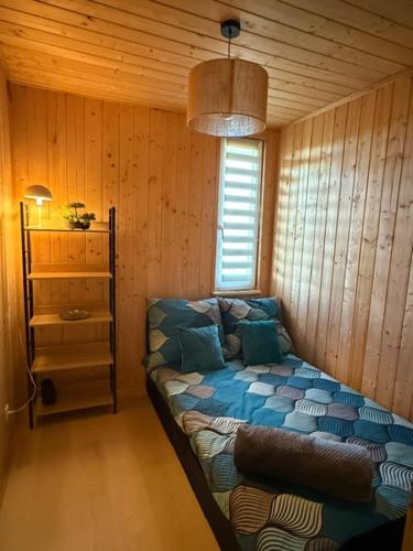 a room with a couch in the corner of a room at Domek na Mazurach - nad jeziorem Dadaj in Wilimy