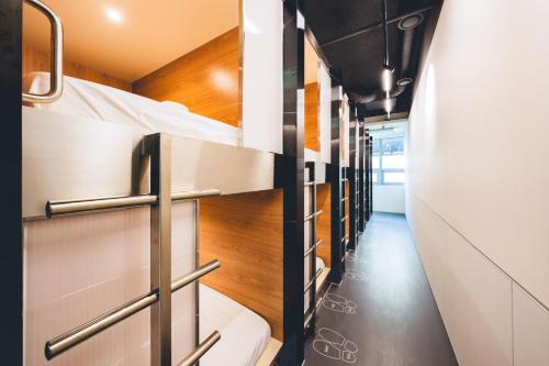 a row of bunk beds in a dorm room at Takt Jongno Female Only Capsule Hotel in Seoul