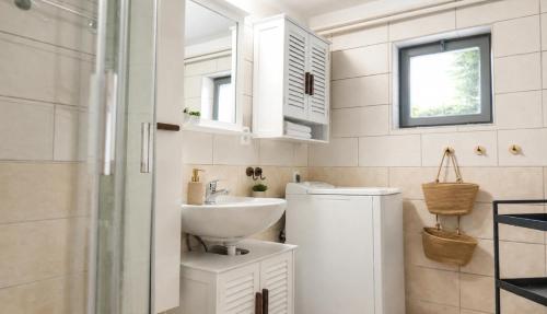 a bathroom with a sink and a washing machine at Seč Aktivně in Seč