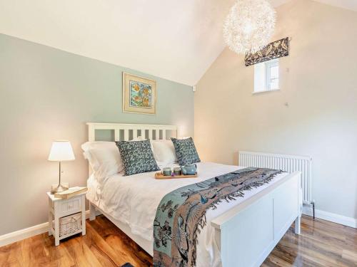 a bedroom with a bed and a chandelier at 1 Bed in Dronfield oc-40971 in Chesterfield