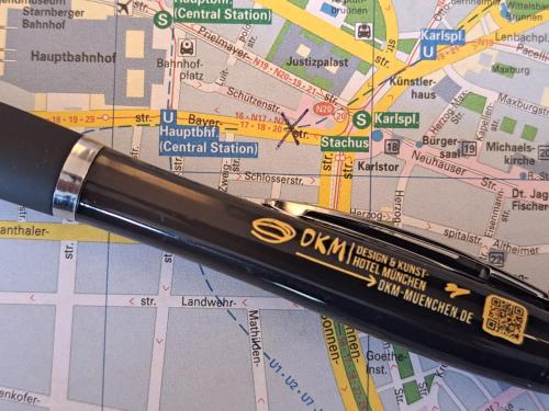 a pen laying on top of a map at Design- und Kunsthotel München in Munich
