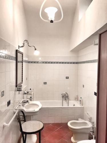 a bathroom with a tub and a sink and a toilet at La Casa Del Nonno Raffaele- Country house in Ravello