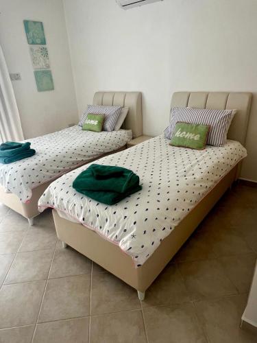 two beds sitting next to each other in a room at Sea View Pool 2BR Esentepe in Kalogrea