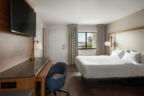 a hotel room with a bed and a desk and a chair at Fairfield by Marriott Anaheim Resort in Anaheim