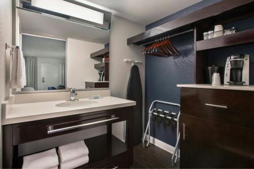 a bathroom with a sink and a mirror at Fairfield by Marriott Anaheim Resort in Anaheim