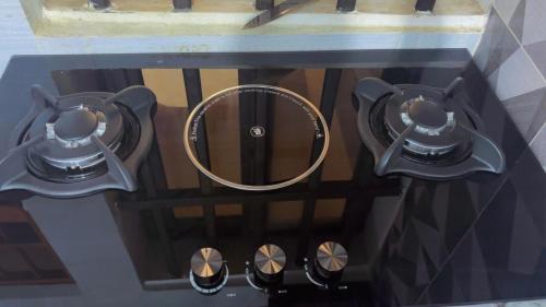 an overhead view of a stove with two knobs at Elite Solutions Apartments in Ouéga