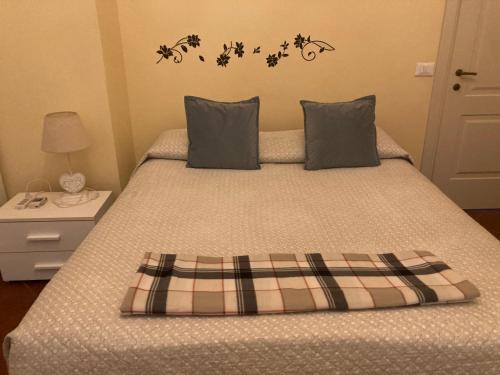 a bedroom with a bed with a plaid blanket at Villa Fontana in Capannori