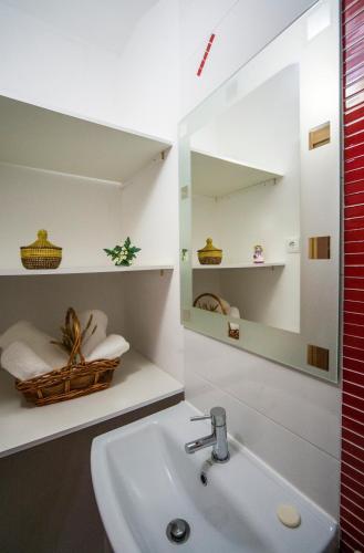 a bathroom with a sink and a mirror at Casa da Liberdade em Nazaré in Nazaré