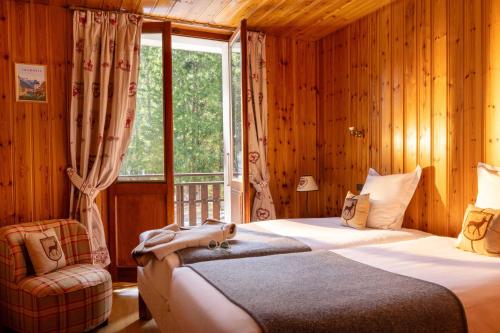 a bedroom with two beds and a window at L'Arveyron Open House in Chamonix