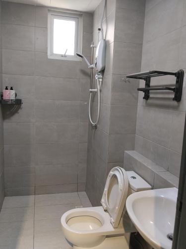 a bathroom with a toilet and a sink at Metropol Summer Cozy Suite in Bukit Mertajam