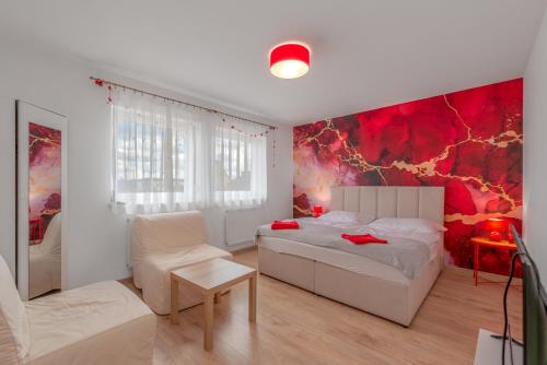 a bedroom with a white bed and a red wall at Suchohrdelská VILLA u vinařství LAHOFER - RD NOVOSTAVBA v Suchohrdly u Znojma - 2 - 10 osob, 2 apartments in Suchohrdly
