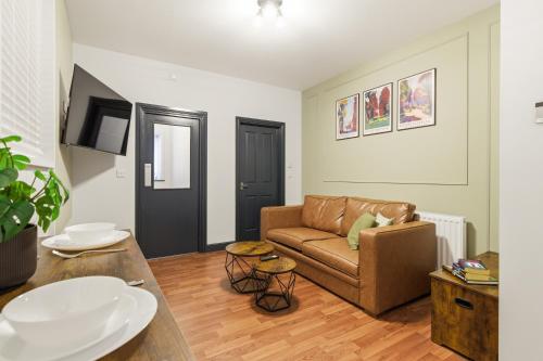 a living room with a couch and a table at Clayton Apartments in Newcastle upon Tyne