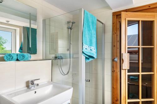 a bathroom with a sink and a shower at Haus am See in Witzin