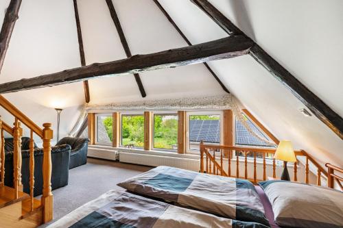 a bedroom with a bed and a window at Haus am See in Witzin