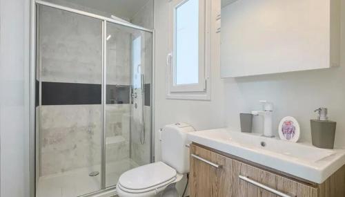 a bathroom with a shower and a toilet and a sink at Camping Bijela Uvala - Roan in Poreč