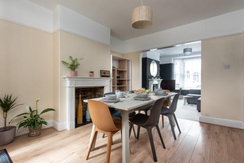 a dining room and living room with a table and chairs at Spacious 3 Bed In Rugby in Rugby