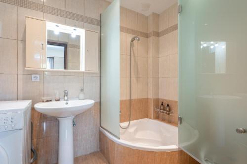 a bathroom with a sink and a shower and a toilet at Villa Melenia 1 in Agia Pelagia