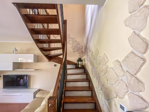 a staircase in a house with a stone wall at Casa Le Marie in Barberino di Mugello