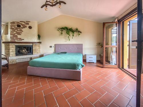 a bedroom with a bed and a fireplace at Casa Le Marie in Barberino di Mugello