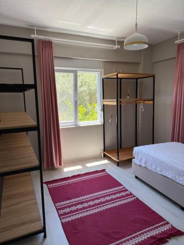 a bedroom with a bed and a window at Adrasan village house in Kumluca
