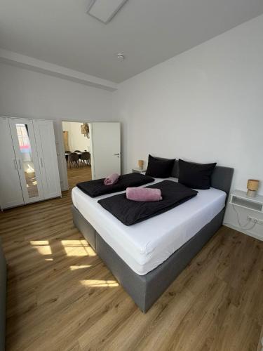 a bedroom with a large bed with two pink pillows on it at Ferienwohnung Franka in Sonneberg