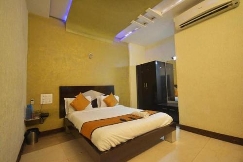 a bedroom with a large bed in a room at Hotel Jasmine in Ahmedabad