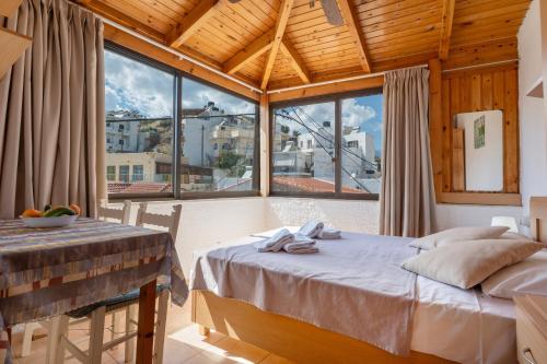 a bedroom with a bed and a large window at Nikos House in Ierapetra