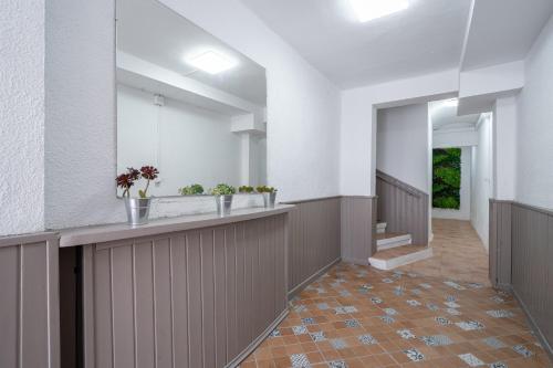 a hallway with a counter with potted plants on it at Cambrils Turistic 3a in Cambrils