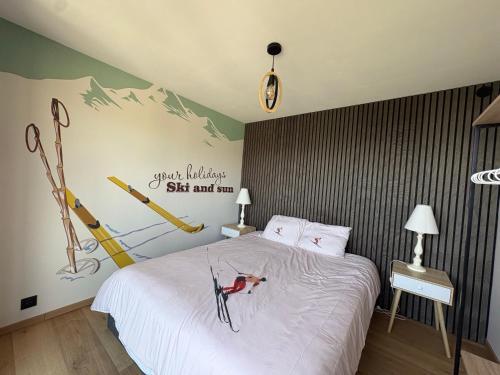 a bedroom with a bed with a dog on it at Flocons 48 in Villarembert