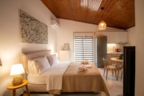 a bedroom with a bed and a kitchen at Cocoon Urban Suites in Kavála