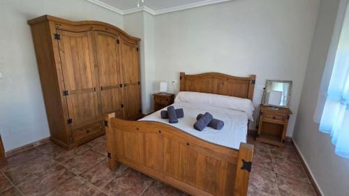 a bedroom with a large wooden bed and a mirror at Casa de Cope in Calabardina