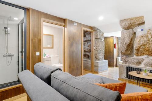 a living room with a couch and a fireplace at Casa do Moinho in Aboim