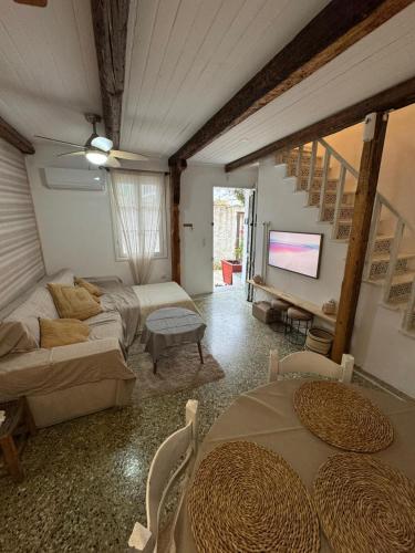 a living room with a couch and a tv at Blau Haus Townhouse in Lefkada