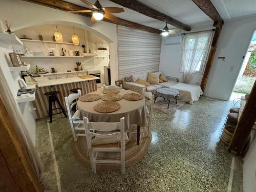 a kitchen and a living room with a table and chairs at Blau Haus Townhouse in Lefkada