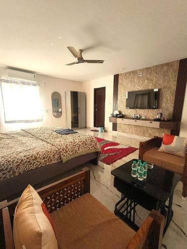 a bedroom with a bed and a living room at Newly Launched Servostay Luxe Botique Hotel Near Miyapur Metro in Lingampalli