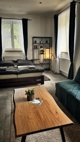 a living room with two beds and a coffee table at podZZamkem in Jaroslavice