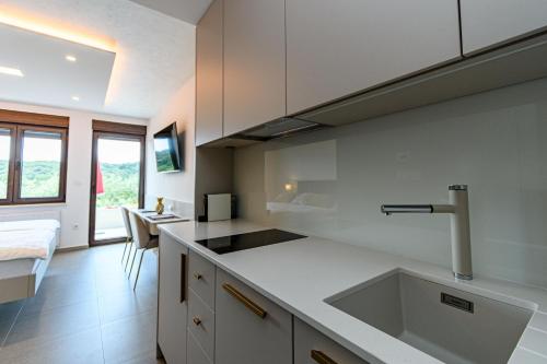 a kitchen with a sink and a counter top at Apartments Villa Ana in Palit